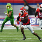 
              Georgia defensive back Christopher Smith (29) runs the ball after an interception in the first half of an NCAA college football game against Oregon, Saturday, Sept. 3, 2022, in Atlanta. (AP Photo/John Bazemore)
            