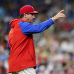 
              FILE - Philadelphia Phillies interim manager Rob Thomson points to the bullpen during a baseball game against the Atlanta Braves, Wednesday, June 29, 2022, in Philadelphia. Thomson has led his team to the brink of the playoffs. The Phillies' magic number is eight as they open a 10-game road trip Tuesday at Wrigley Field. If the Phillies keep their third wild-card spot, it’s off to St. Louis for a best-of-three series played all in Missouri. (AP Photo/Matt Slocum, File)
            