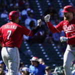 
              Cincinnati Reds' Jake Fraley, right, celebrates with Donovan Solano after hitting a solo home run against the Chicago Cubs during the second inning of a baseball game in Chicago, Friday, Sept. 30, 2022. (AP Photo/Nam Y. Huh)
            