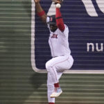 
              Boston Red Sox center fielder Abraham Almonte misplays the catch on a deep drive by New York Yankees' Gleyber Torres, which drove in a run, during the ninth inning of a baseball game at Fenway Park, Wednesday, Sept. 14, 2022, in Boston. Almonte was charged with an error on the play. (AP Photo/Charles Krupa)
            
