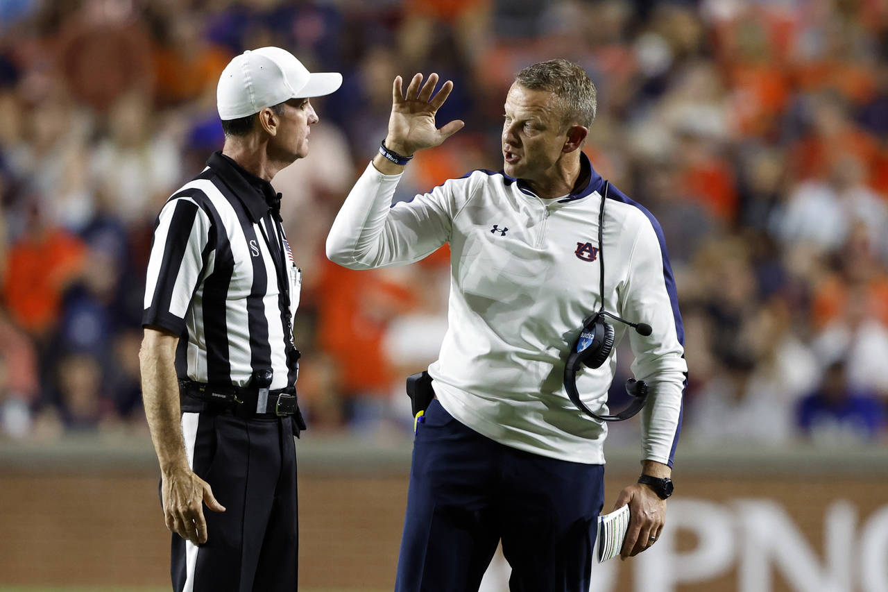 Auburn head coach Bryan Harsin talks with the referee Ken Williamson during the second half of an N...