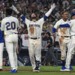 
              Seattle Mariners' Eugenio Suarez, center, celebrates with Luis Castillo, left, Taylor Trammell (20), Julio Rodriguez, second from right, and third base coach Manny Acta, right, after hitting a walkoff solo home run after a baseball game against the Atlanta Braves, Sunday, Sept. 11, 2022, in Seattle. (AP Photo/Stephen Brashear)
            