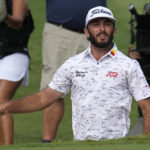 
              Max Homa jumps up from the bunker on the 18th during the weather delayed third round of the Tour Championship golf tournament at East Lake Golf Club Sunday, Aug. 28, 2022, in Atlanta. (AP Photo/Steve Helber)
            
