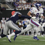 
              New York Giants quarterback Daniel Jones (8) runs the ball for a first down against Dallas Cowboys defensive end DeMarcus Lawrence (90) during the third quarter of an NFL football game, Monday, Sept. 26, 2022, in East Rutherford, N.J. (AP Photo/Adam Hunger)
            