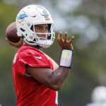 
              FILE - Miami Dolphins quarterback Tua Tagovailoa sets up to pass during NFL football training camp, Monday, Sept. 5, 2022, in Miami Gardens, Fla. Tua Tagovailoa and Mac Jones will be forever linked by their time as Alabama teammates. Now, for the second consecutive year, they'll meet in Week 1 of the NFL season. (David Santiago/Miami Herald via AP, File)
            