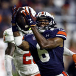 
              Auburn wide receiver Ja'Varrius Johnson (6) catches a pass as Mercer cornerback TJ Moore (25) defends during the second half of an NCAA college football game Saturday, Sept. 3, 2022, in Auburn, Ala. (AP Photo/Butch Dill)
            
