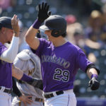 
              Colorado Rockies' Yonathan Daza, left, congratulates Michael Toglia as he crosses home plate after hitting a three-run home run off Milwaukee Brewers starting pitcher Eric Lauer in the third inning of a baseball game Wednesday, Sept. 7, 2022, in Denver. (AP Photo/David Zalubowski)
            