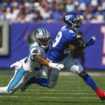 
              New York Giants' Kadarius Toney, right, tries to avoid a tackle by Carolina Panthers' Myles Hartsfield during the first half an NFL football game, Sunday, Sept. 18, 2022, in East Rutherford, N.J. (AP Photo/John Munson)
            