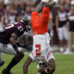 
              Sam Houston State wide receiver Ife Adeyi (2) flips upside down as Texas A&M defensive back Antonio Johnson (27) defends during the first half of an NCAA college football game Saturday, Sept. 3, 2022, in College Station, Texas. (AP Photo/David J. Phillip)
            