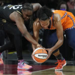 
              Las Vegas Aces guard Chelsea Gray, left, and Connecticut Sun forward Alyssa Thomas (25) battle for the ball during the first half in Game 2 of a WNBA basketball final playoff series Tuesday, Sept. 13, 2022, in Las Vegas. (AP Photo/John Locher)
            