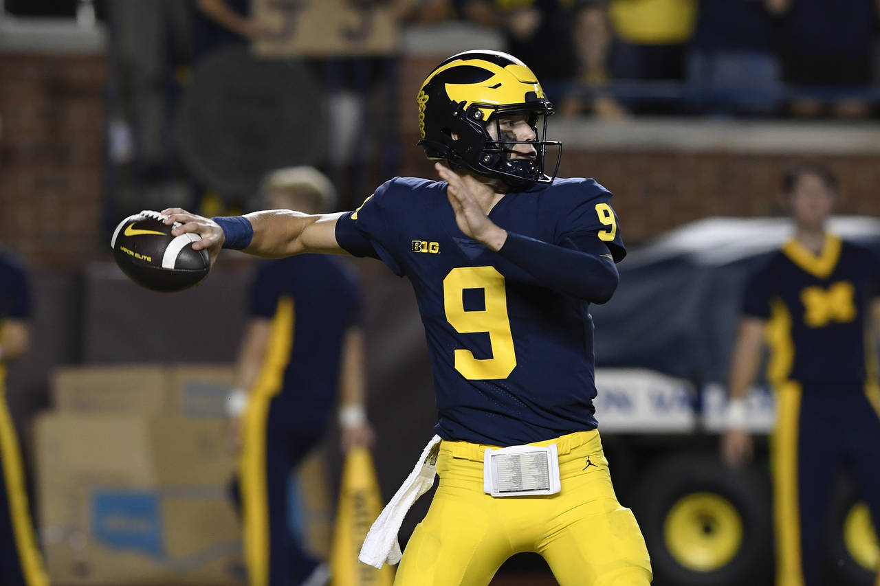 Michigan quarterback J.J. McCarthy throws against Hawaii during the first half of an NCAA college f...