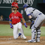 
              Toronto Blue Jays catcher Danny Jansen, right, watches as Texas Rangers's Leody Taveras, left, reacts after being hit by a pitch during the seventh inning of a baseball game Friday, Sept. 9, 2022, in Arlington, Texas. (AP Photo/Michael Ainsworth)
            