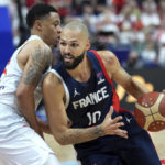 
              Evan Fournier of France, right, is challenged by Poland's A.J. Slaughter, left, during the Eurobasket semi final basketball match between Poland and France in Berlin, Germany, Friday, Sept. 16, 2022. (AP Photo/Michael Sohn)
            