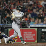 
              Oakland Athletics' Seth Brown (15) watches his three-run home run along with Houston Astros catcher Christian Vazquez during the fifth inning of a baseball game Saturday, Sept. 17, 2022, in Houston. (AP Photo/David J. Phillip)
            