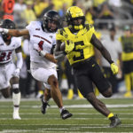 
              Oregon running back Sean Dollars (5) is chased byEastern Washington defensive back Anthany Smith (4) during the third quarter of an NCAA college football game Saturday, Sept. 10, 2022, in Eugene, Ore. (AP Photo/Andy Nelson)
            