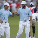 
              Collin Morikawa, left, and Cameron Young celebrate on the 15th green during their foursomes match at the Presidents Cup golf tournament at the Quail Hollow Club, Thursday, Sept. 22, 2022, in Charlotte, N.C. (AP Photo/Julio Cortez)
            