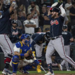 
              Atlanta Braves' Robbie Grossman is congratulated by Eddie Rosario after hitting a two-run home run off Seattle Mariners relief pitcher Paul Sewald during the ninth inning of a baseball game, Sunday, Sept. 11, 2022, in Seattle. The Mariners won 8-7. (AP Photo/Stephen Brashear)
            