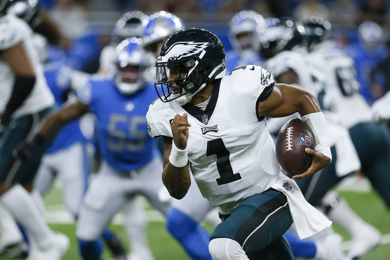 Philadelphia Eagles quarterback Jalen Hurts (1) runs the ball against the Detroit Lions in the firs...