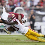 
              Southern California defensive back Latrell McCutchin (21) tackles Stanford wide receiver Elijah Higgins during the first half of an NCAA college football game in Stanford, Calif., Saturday, Sept. 10, 2022. (AP Photo/Godofredo A. Vásquez)
            