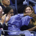 
              Michelle Obama, center, gives two thumbs up to Frances Tiafoe, of the United States, during a semifinal match between Tiafoe and Carlos Alcaraz, of Spain, at the U.S. Open tennis championships, Friday, Sept. 9, 2022, in New York. (AP Photo/John Minchillo)
            
