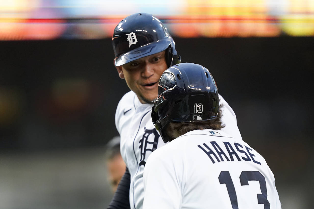 Detroit Tigers' Miguel Cabrera celebrates with Eric Haase (13) after hitting a two-run home run aga...