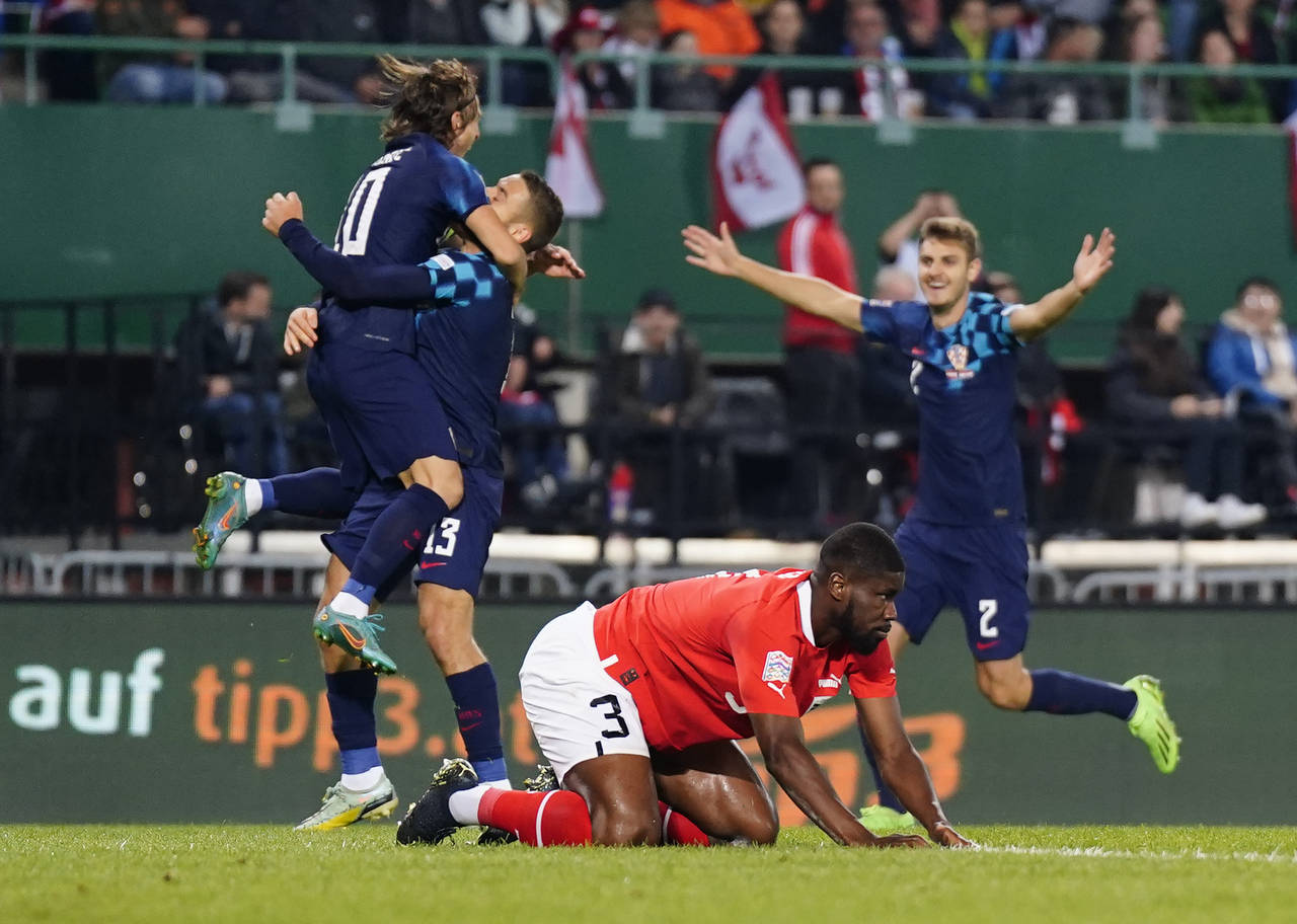 Austria's Kevin Danso, front, reacts after Croatia's Luka Modric scoring his side's opening goal du...