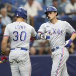 
              Texas Rangers' Corey Seager, right, celebrates with teammate Nathaniel Lowe (30) after hitting a home run against the Tampa Bay Rays during the fith inning of a baseball game, Sunday, Sept. 18, 2022, in St. Petersburg, Fla. (AP Photo/Mark LoMoglio)
            