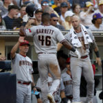 
              Arizona Diamondbacks' Stone Garrett (46) is congratulated at the top of the dugout by manager Torey Lovullor, left, after hitting a solo home run in the seventh inning during a baseball game against the San Diego Padres, Monday, Sept. 5, 2022, in San Diego. (AP Photo/Brandon Sloter)
            