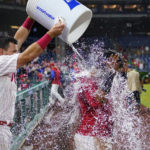 
              Philadelphia Phillies' Jean Segura, right, is doused by Kyle Schwarber after hitting a game-winning RBI-single during the ninth inning of a baseball game against the Miami Marlins, Tuesday, Sept. 6, 2022, in Philadelphia. (AP Photo/Matt Slocum)
            