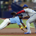 
              Tampa Bay Rays' Manuel Margot dives back safely ahead of the pickoff throw to Toronto Blue Jays first baseman Vladimir Guerrero Jr. during the first inning of a baseball game Thursday, Sept. 22, 2022, in St. Petersburg, Fla. (AP Photo/Chris O'Meara)
            