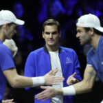 
              Team Europe's Roger Federer, center, looks at Andy Murray, left, and Matteo Berrettini during a match against Team World's Jack Sock and Felix Auger-Aliassime on final day of the Laver Cup tennis tournament at the O2 in London, Sunday, Sept. 25, 2022. (AP Photo/Kin Cheung)
            