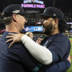 
              Seattle Mariners manager Scott Servais, left, and Eugenio Suarez embrace after the team's baseball game against the Oakland Athletics, Friday, Sept. 30, 2022, in Seattle. The Mariners won 2-1 to clinch a spot in the playoffs. (AP Photo/Stephen Brashear)
            