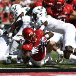 
              Louisville running back Tiyon Evans (7) fights his way across the goal line to score during the second half of an NCAA college football game against South Florida in Louisville, Ky., Saturday, Sept. 24, 2022. Louisville won 41-3. (AP Photo/Timothy D. Easley)
            