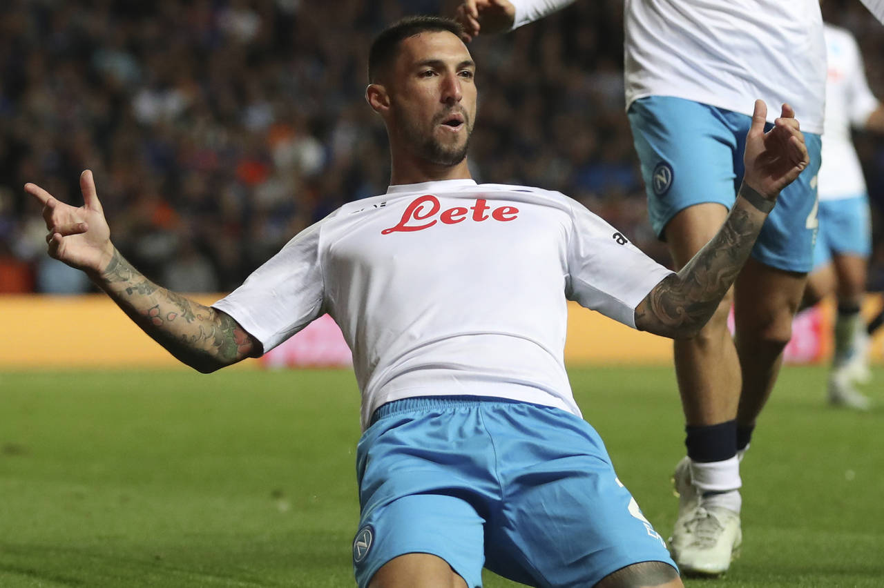 Napoli's Matteo Politano celebrates after scoring his side's opening goal from a penalty shot durin...