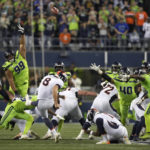 
              Denver Broncos place kicker Brandon McManus (8) attempts a field goal as Seattle Seahawks defensive tackle Al Woods (99) attempts the block during the second half of an NFL football game, Monday, Sept. 12, 2022, in Seattle. The kick went wide and the Seahawks won 17-16. (AP Photo/Stephen Brashear)
            