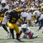 
              Michigan running back Blake Corum (2) runs for an 11-yard touchdown against Connecticut in the second half of an NCAA college football game in Ann Arbor, Mich., Saturday, Sept. 17, 2022. (AP Photo/Paul Sancya)
            