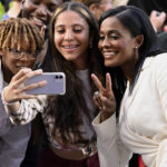 
              Swin Cash, right, poses for photos with fans as she arrives for the Basketball Hall of Fame enshrinement ceremony Saturday, Sept. 10, 2022, in Springfield, Mass. (AP Photo/Jessica Hill)
            