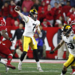 
              Iowa quarterback Spencer Petras (7) throws a pass against Rutgers defensive linemen Wesley Bailey (23) and Kenny Fletcher (12) during the second half of an NCAA college football game, Saturday, Sept. 24, 2022, in Piscataway, N.J. (AP Photo/Noah K. Murray)
            