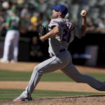
              New York Mets starting pitcher Max Scherzer (21) throws in the sixth inning of a baseball game against the Oakland Athletics in Oakland, Calif., on Sunday, Sept. 25, 2022. (AP Photo/Scot Tucker)
            