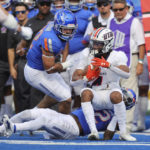 
              Tennessee-Martin wide receiver DeVonte Tanksley (4) is is pulled down by Boise State cornerback Tyric LeBeauf (22) as Boise State linebacker DJ Schramm (52) comes into finish the tackle in the second half of an NCAA college football game, Saturday, Sept. 17, 2022, in Boise, Idaho. (AP Photo/Steve Conner)
            