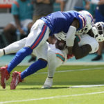 
              Buffalo Bills safety Jaquan Johnson (4) takes Miami Dolphins wide receiver Tyreek Hill (10) during the first half of an NFL football game, Sunday, Sept. 25, 2022, in Miami Gardens, Fla. (AP Photo/Rebecca Blackwell)
            