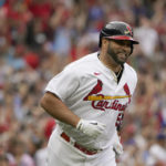 
              St. Louis Cardinals' Albert Pujols smiles as he rounds the bases after hitting a two-run home run during the eighth inning of a baseball game against the Chicago Cubs Sunday, Sept. 4, 2022, in St. Louis. (AP Photo/Jeff Roberson)
            