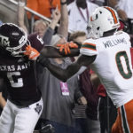 
              Miami safety James Williams (0) grabs the face mask of Texas A&M running back Devon Achane (6) while trying to tackle him during the first quarter of an NCAA college football game Saturday, Sept. 17, 2022, in College Station, Texas. (AP Photo/Sam Craft)
            