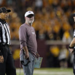 
              New Mexico State coach Jerry Kill, middle, looks on during a replay review ing the first half of the team's NCAA college football game against Minnesota on Thursday, Sept. 1, 2022, in Minneapolis. (AP Photo/Abbie Parr)
            