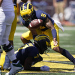 
              Michigan defensive back DJ Turner (5) scoops up the fumble and runs it in for a 45-yard touchdown during the second half of an NCAA college football game against Colorado State, Saturday, Sept. 3, 2022, in Ann Arbor, Mich. (AP Photo/Carlos Osorio)
            