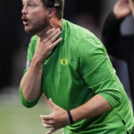 
              Oregon head coach Dan Lanning signals to his players on the field in the first half of an NCAA college football game against Georgia, Saturday, Sept. 3, 2022, in Atlanta. (AP Photo/John Bazemore)
            
