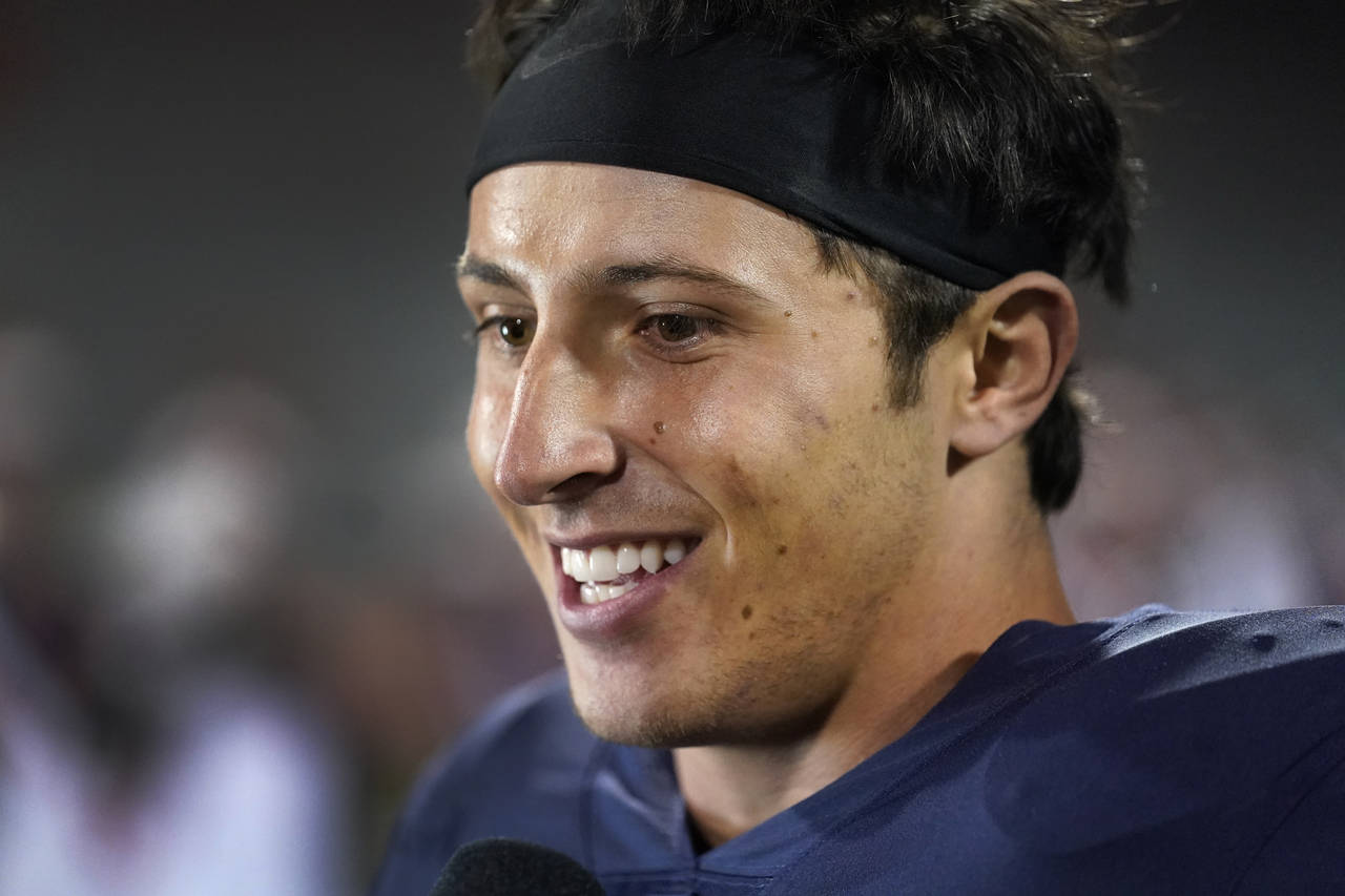 Illinois quarterback Tommy DeVito smiles as he gives a television interview after the team's 31-0 w...
