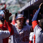 
              Washington Nationals' Joey Meneses (45) is greeted in the dugout after hitting a two-run home run in the seventh inning of a baseball game against the Atlanta Braves, Wednesday, Sept. 21, 2022, in Atlanta. (AP Photo/Brynn Anderson)
            