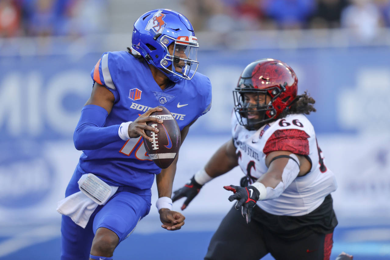Boise State quarterback Taylen Green (10) is chased out of the pocket by San Diego State defensive ...