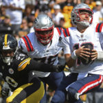 
              New England Patriots quarterback Mac Jones (10) spins out of the reach of Pittsburgh Steelers linebacker Malik Reed (50) during the first half of an NFL football game in Pittsburgh, Sunday, Sept. 18, 2022. (AP Photo/Phil Pavely)
            